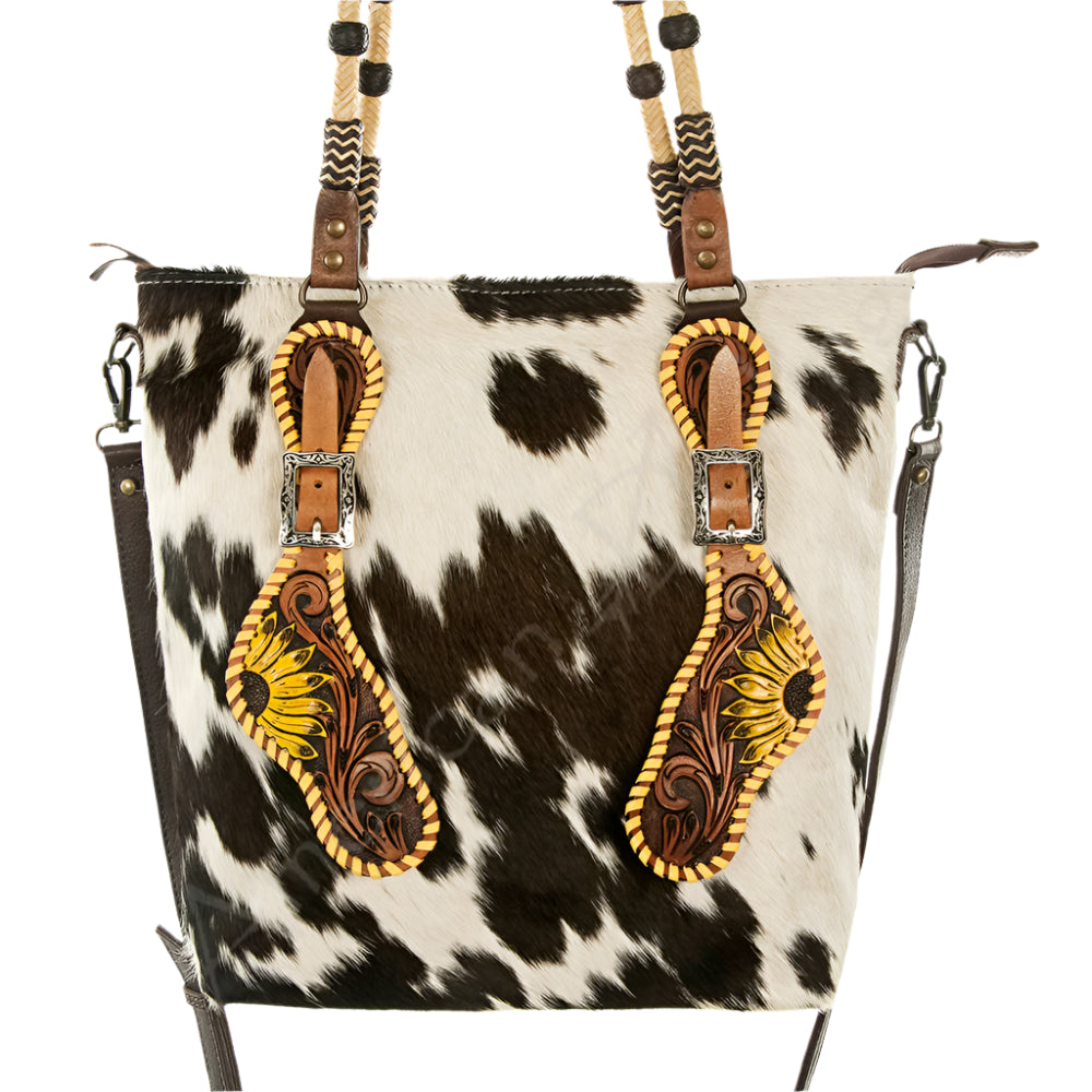 American Darling Cowhide leather bag with decorative western spur strap inspired straps on a white background