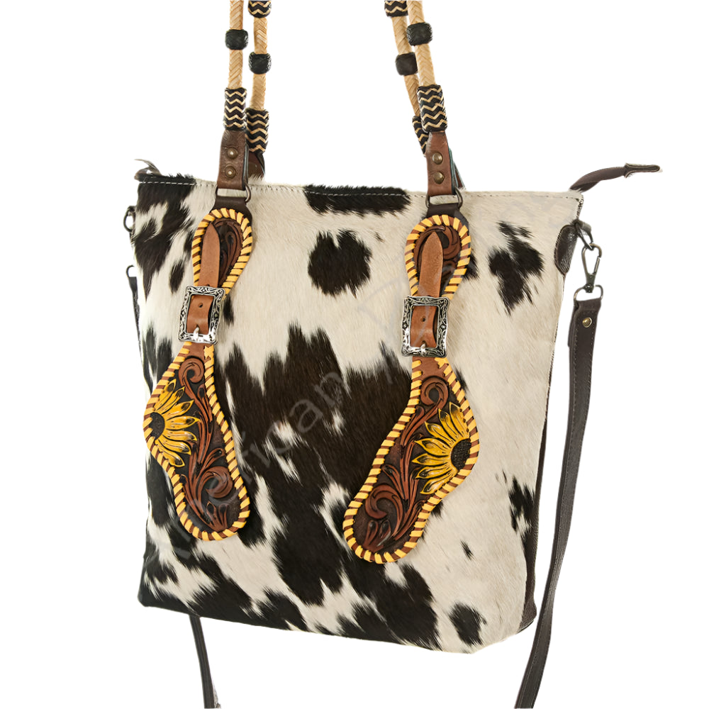 American Darling Cowhide and leather western handbag with decorative straps on a white background