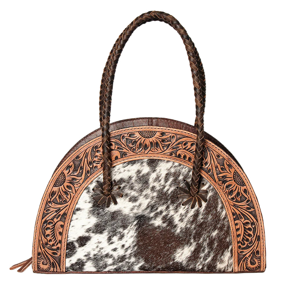 American Darling Tooled & Hide Western Tote. Handbag with cowhide leather and intricate brown leatherwork on a light gray background