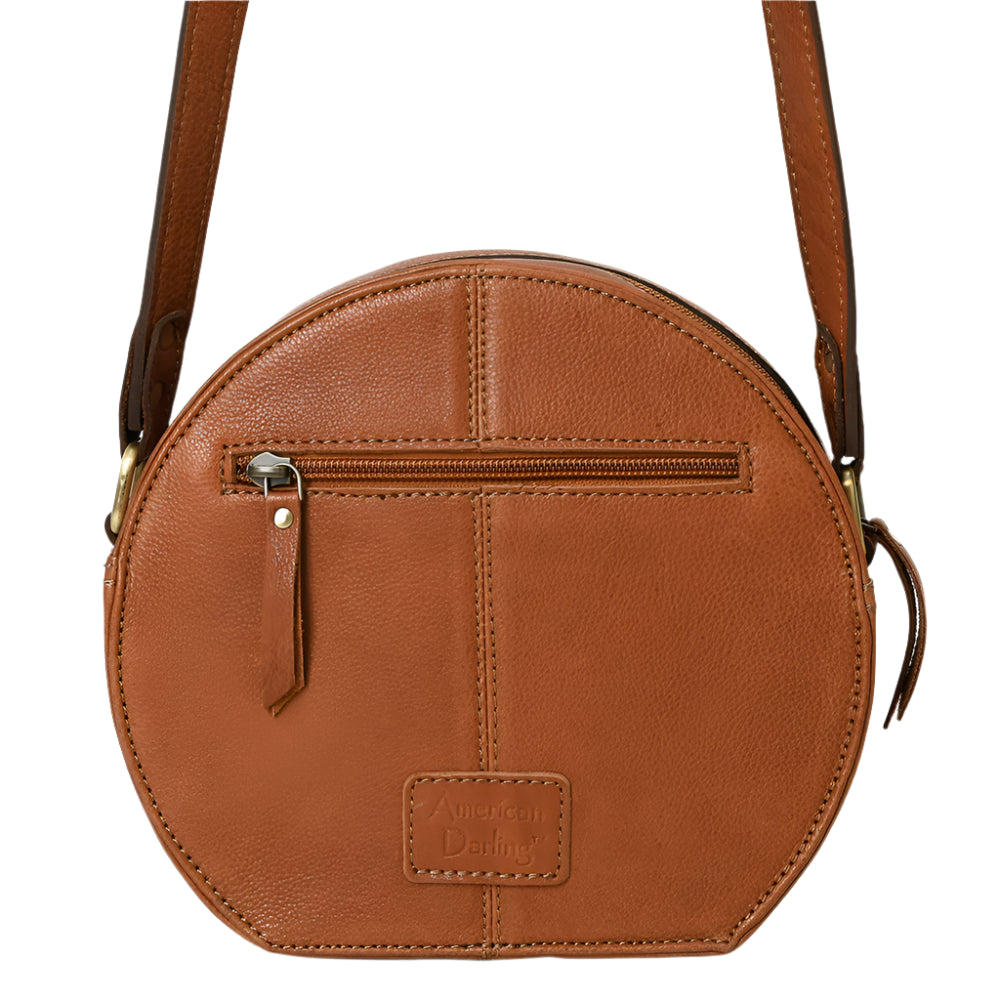American Darling brown, circular, leather western handbag with zippered compartment and a shoulder strap.