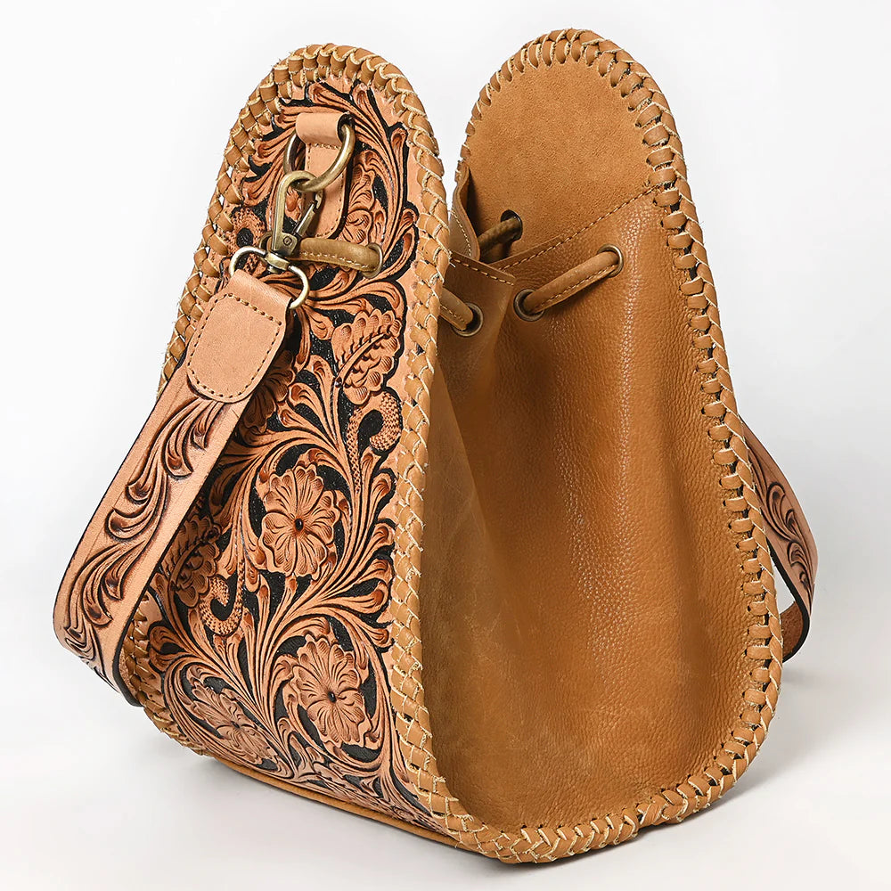 American Darling Western Floral Tooled Leather Sling Bag. Brown leather bag with intricate tooled design on a white background