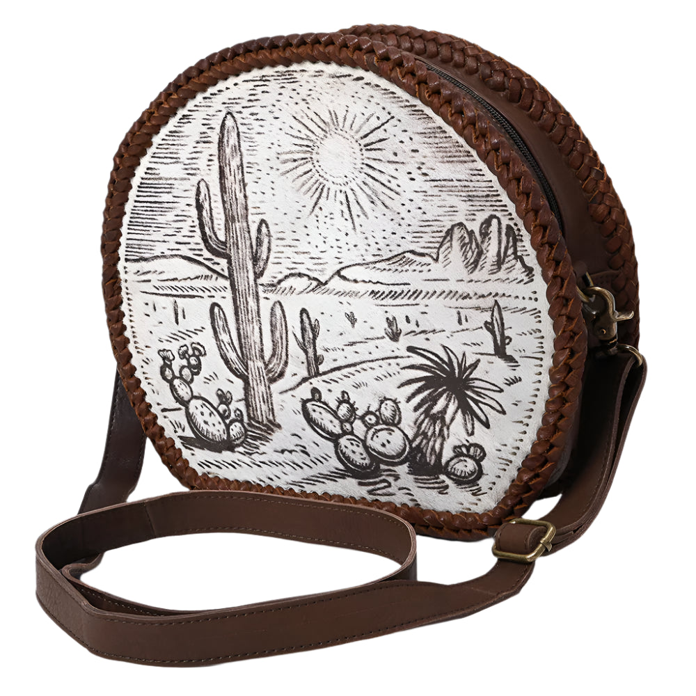 American Darling Round crossbody western bag with desert scene design and brown leather strap on a white background