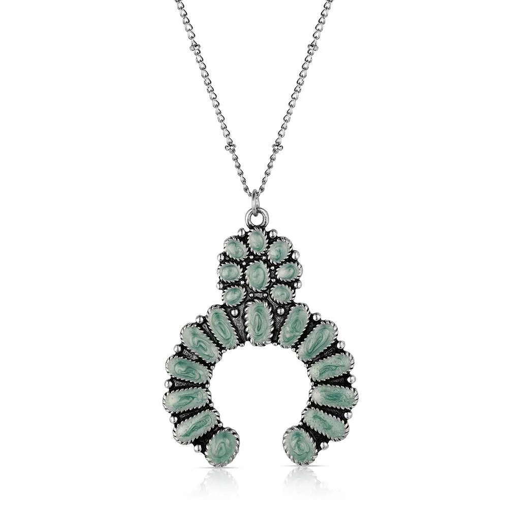 Necklace with a green pendant on a white background