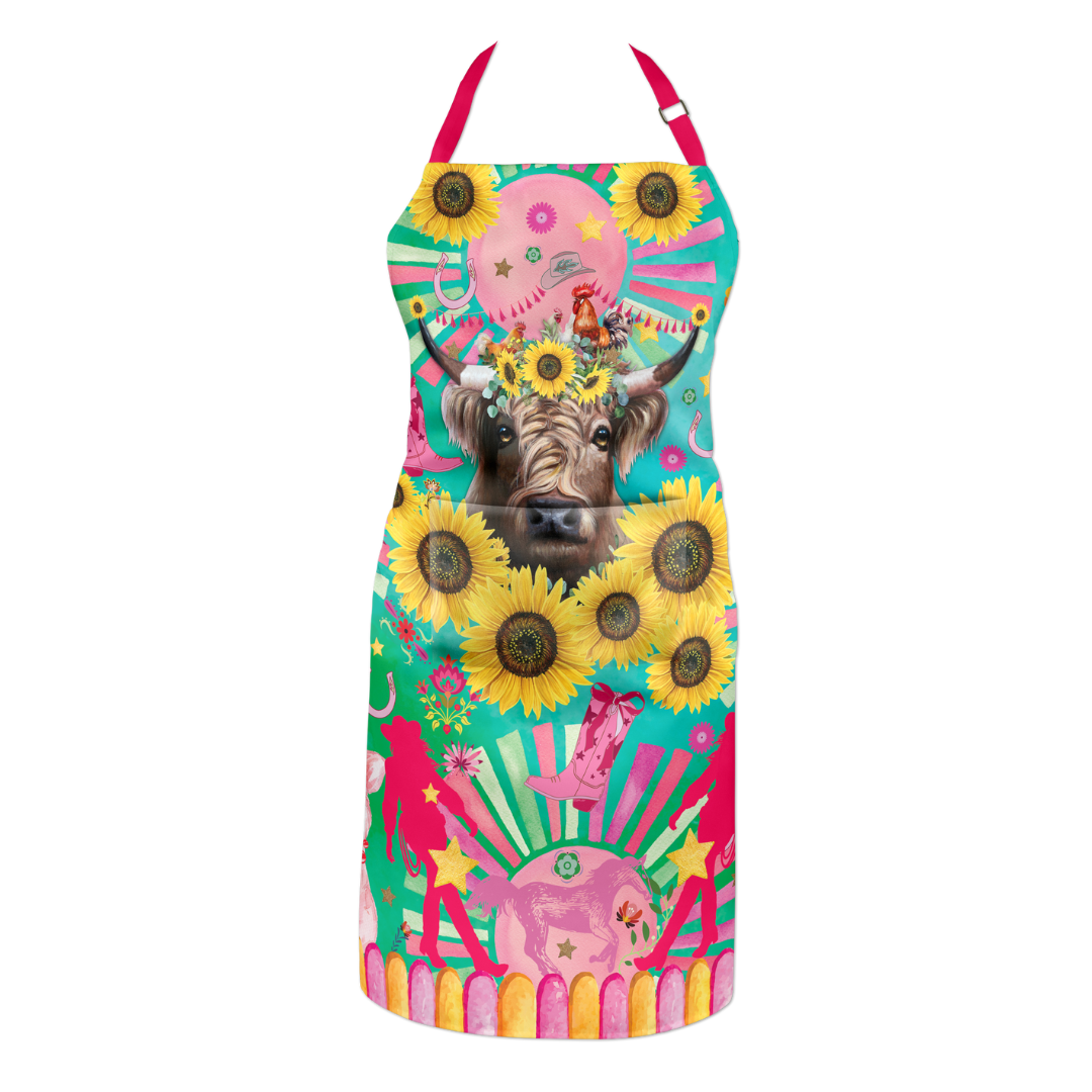 Lisa Pollock Carnival Cow Apron. Colorful apron with a cow and sunflower design on a white background