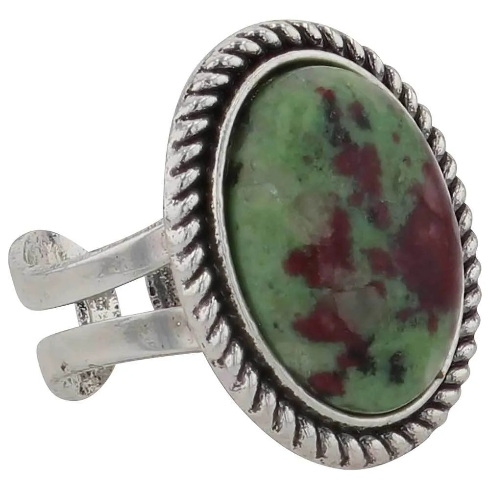 Silver ring with a green and red stone on a white background