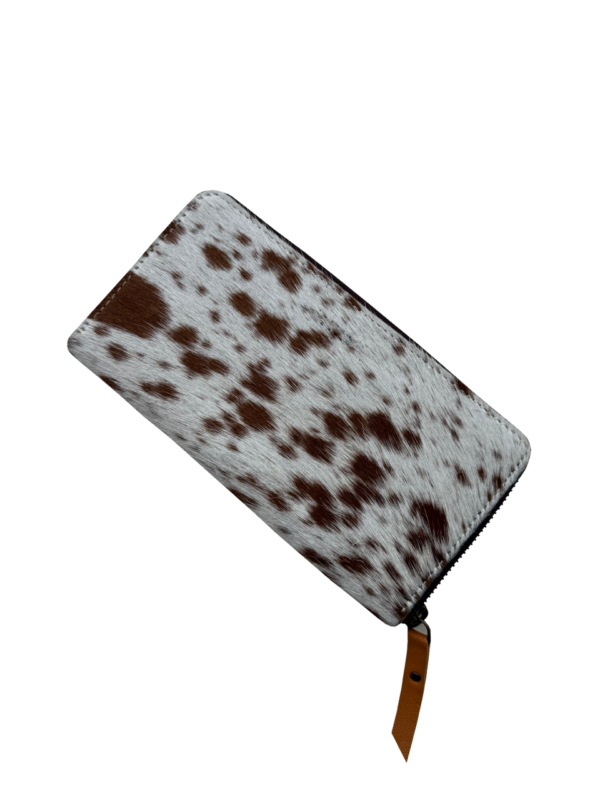 Cowhide Sunflower Tooling Leather Zippered Wallet. Zipper pouch with cow print pattern on a white background