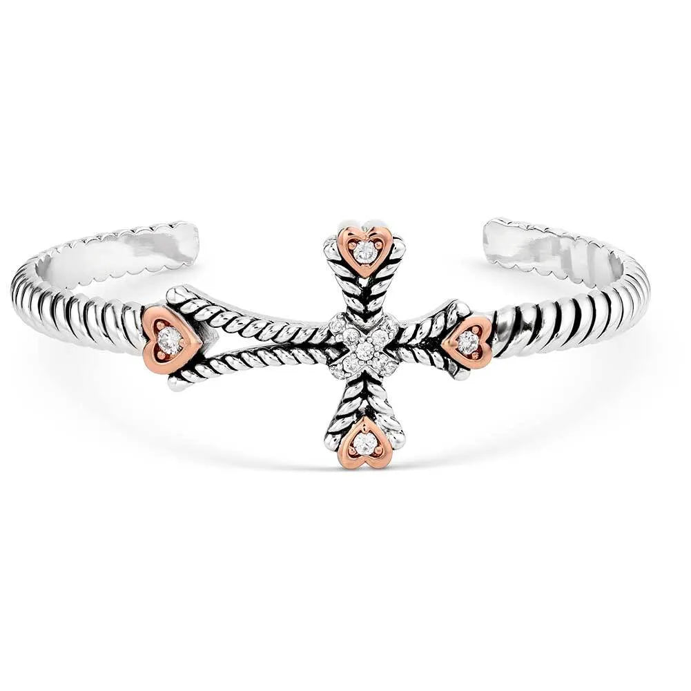 Silver and rose gold open ring with heart and cross design on a white background