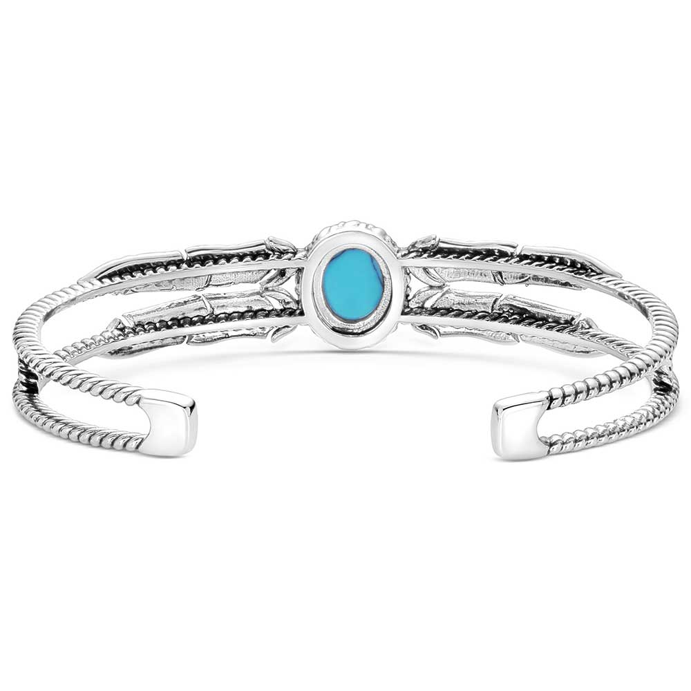 Montana Silversmith a bold crafted turquoise stone anchors the center of the silver tone cuff.