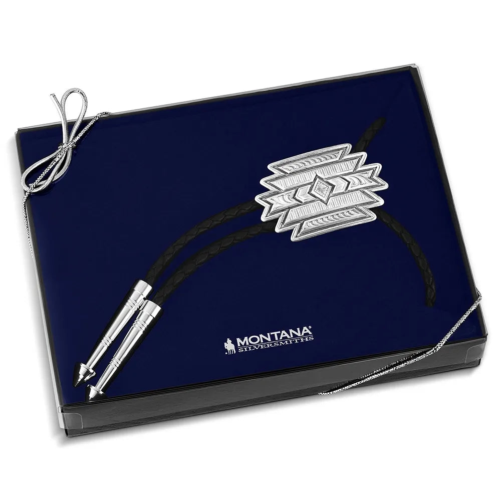 Navy blue box with silver and black decorative item, featuring the Montana Silversmiths logo.