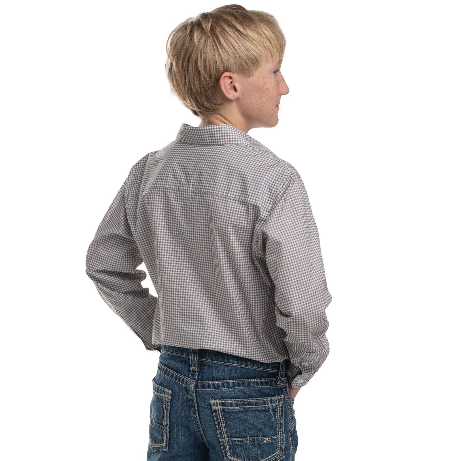 Child wearing a gray checkered shirt and blue jeans on a white background