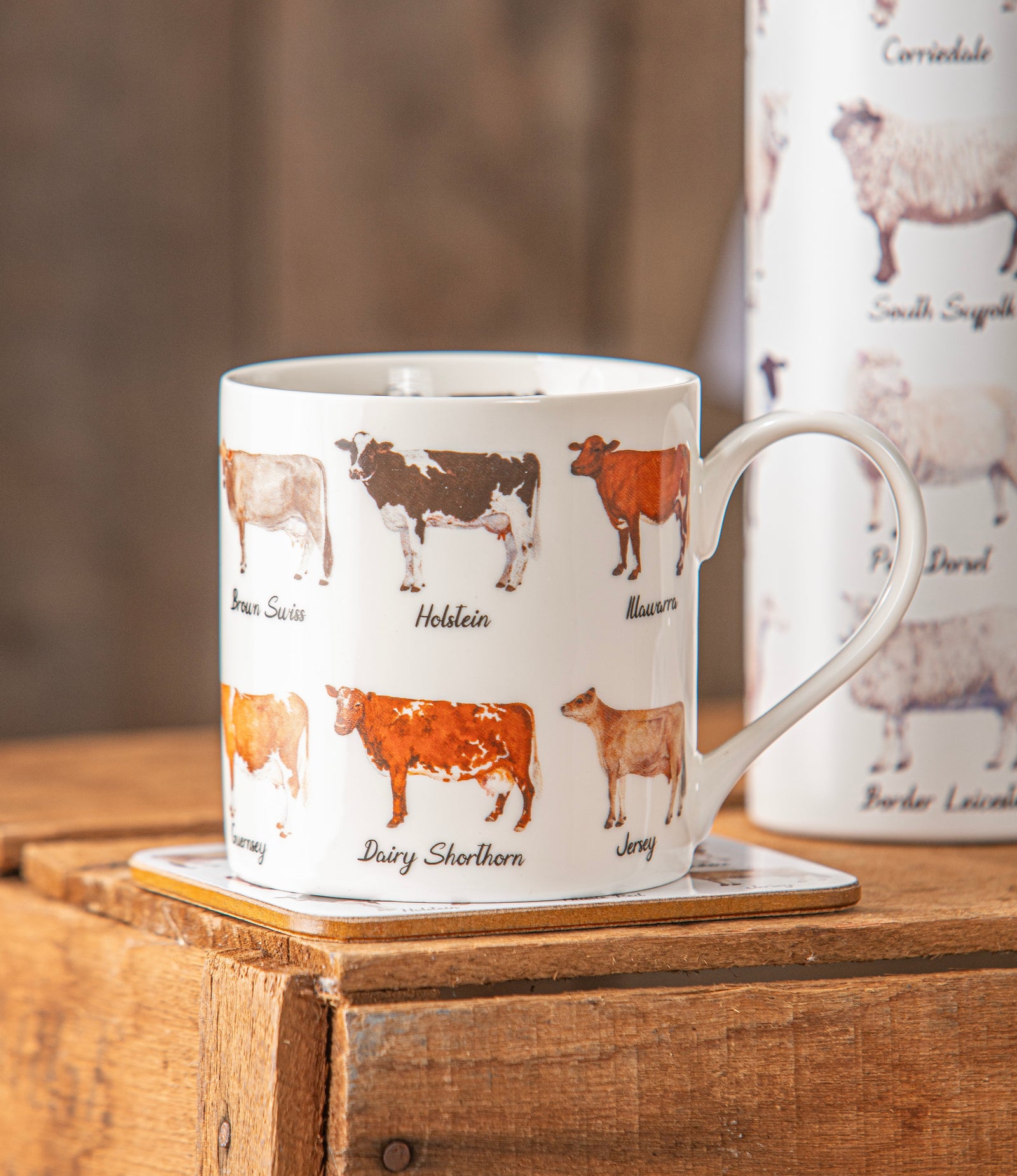 Mug with cow illustrations on a wooden surface