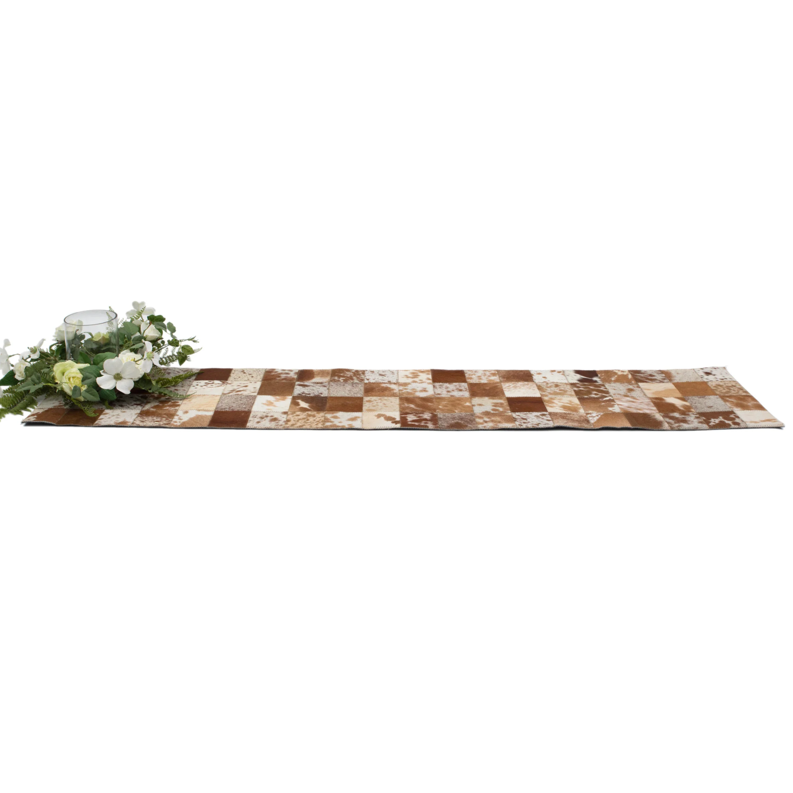 Cowhide Table Runner. Checkered table runner with floral arrangement on a white background