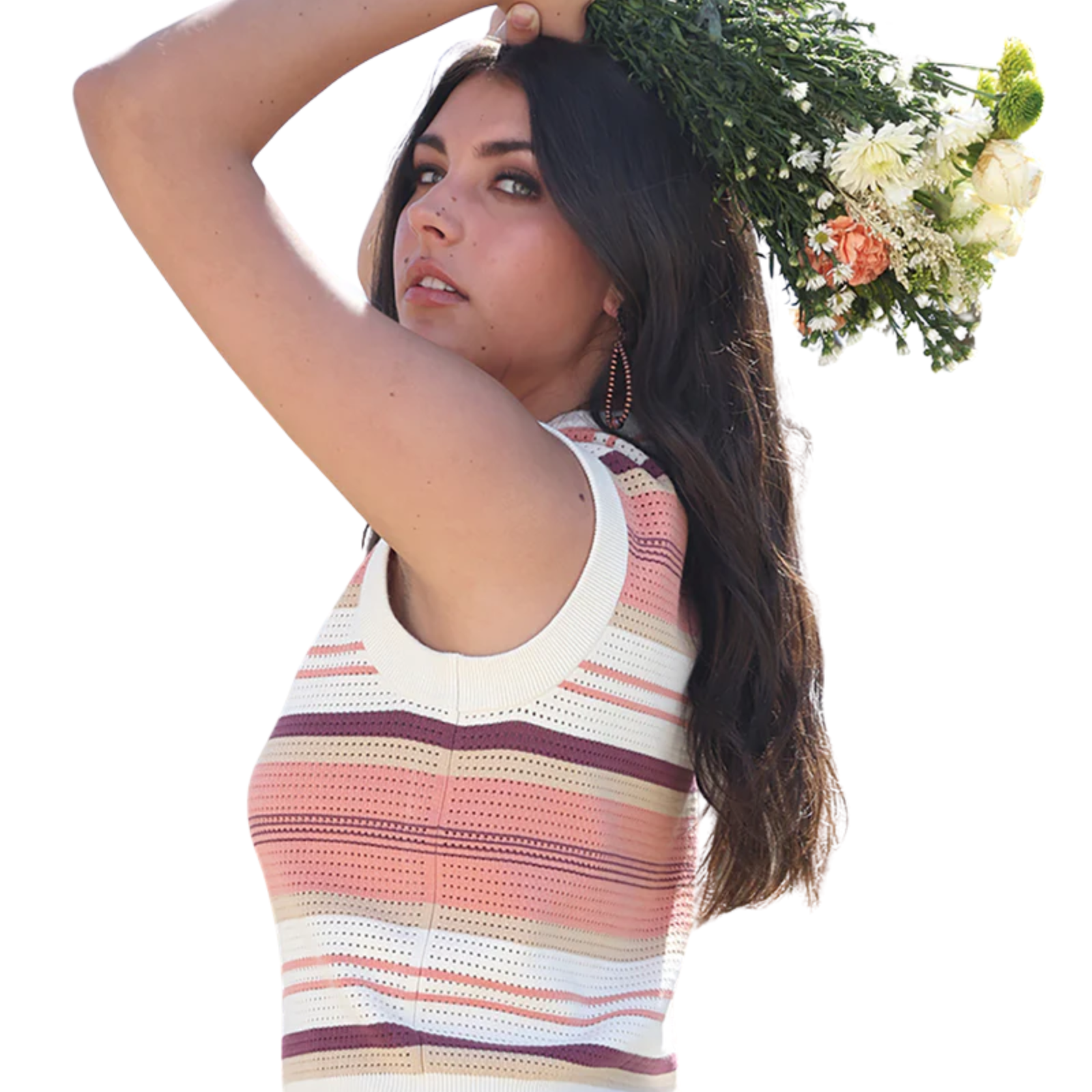 Woman wearing a colorful striped sleeveless top holding flowers against a white background