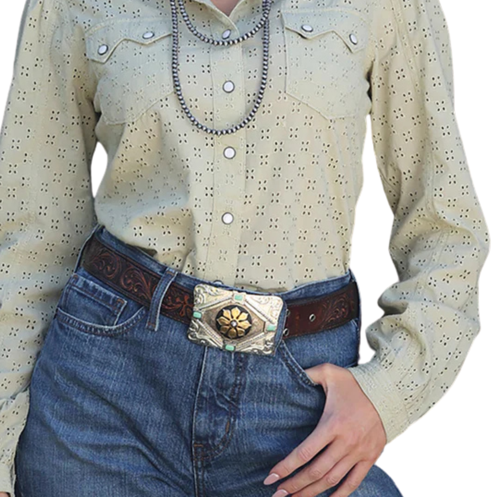 Person wearing a beige long-sleeve shirt with button details and blue jeans with a decorative belt.