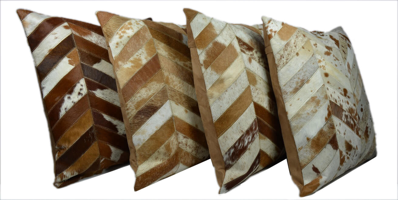 Patched Cowhide Cushion. Set of four patterned pillows with brown and beige colors on a white background