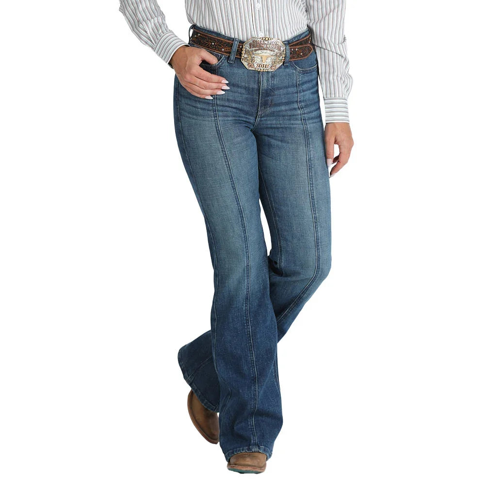 A person wearing blue western-style jeans with a brown belt and large silver buckle, paired with a striped shirt and brown boots, shown against a plain white background.