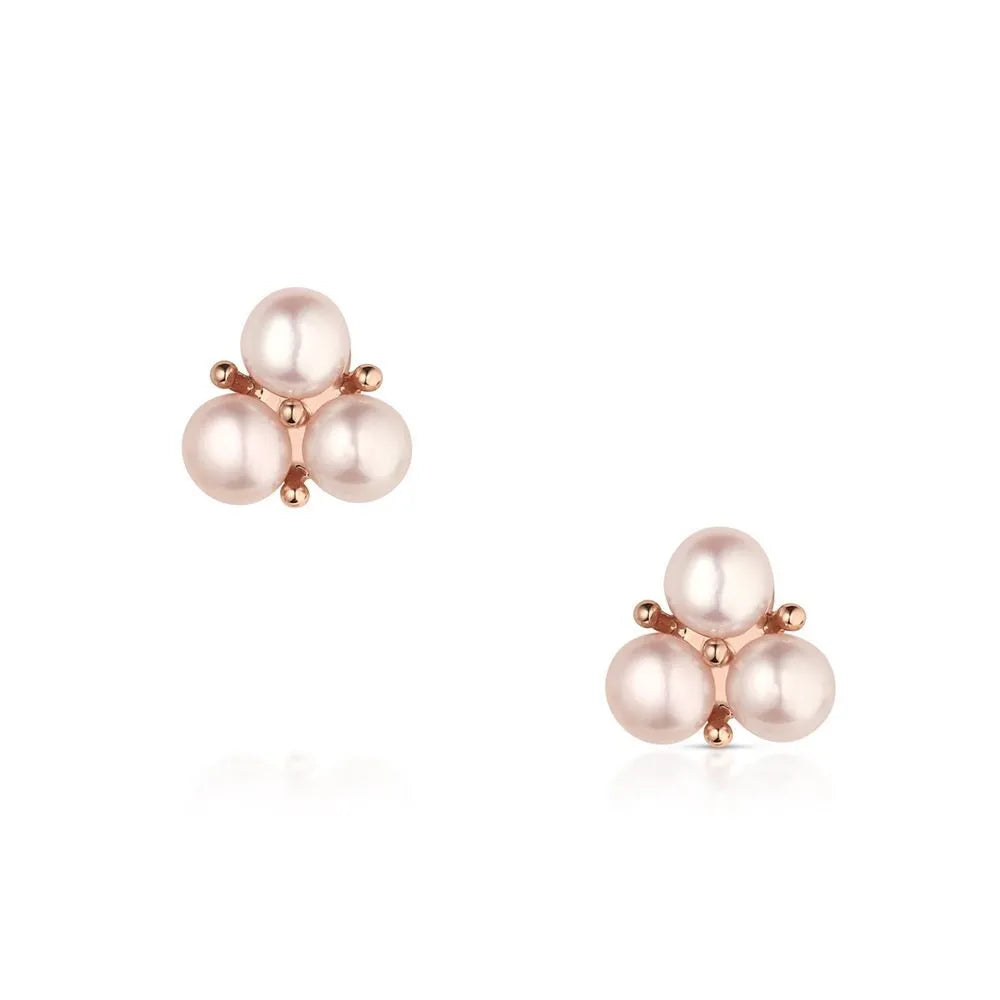 Pair of pearl earrings with rose gold accents on a white background