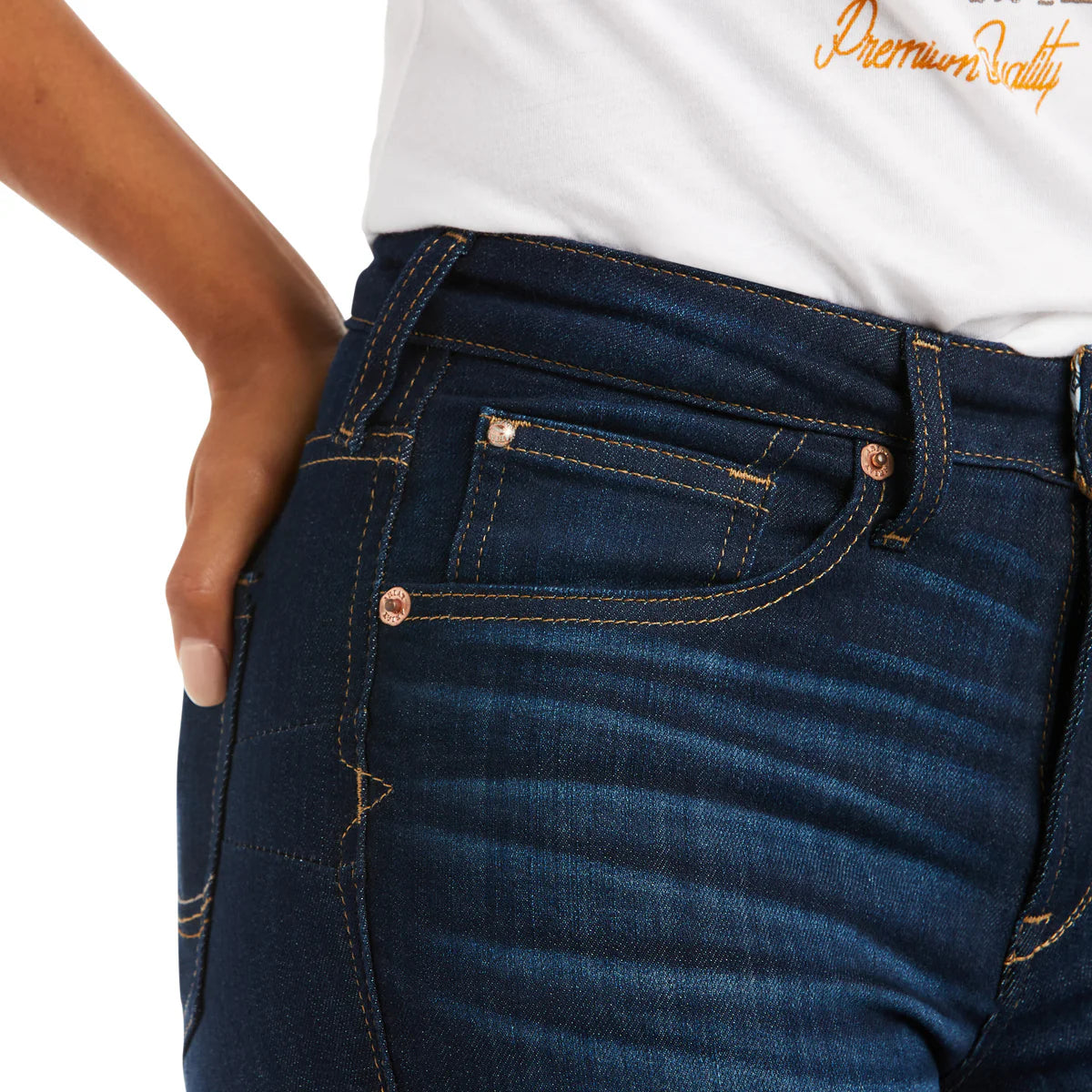 Close-up of blue jeans with a white shirt and 'Premium Quality' text.