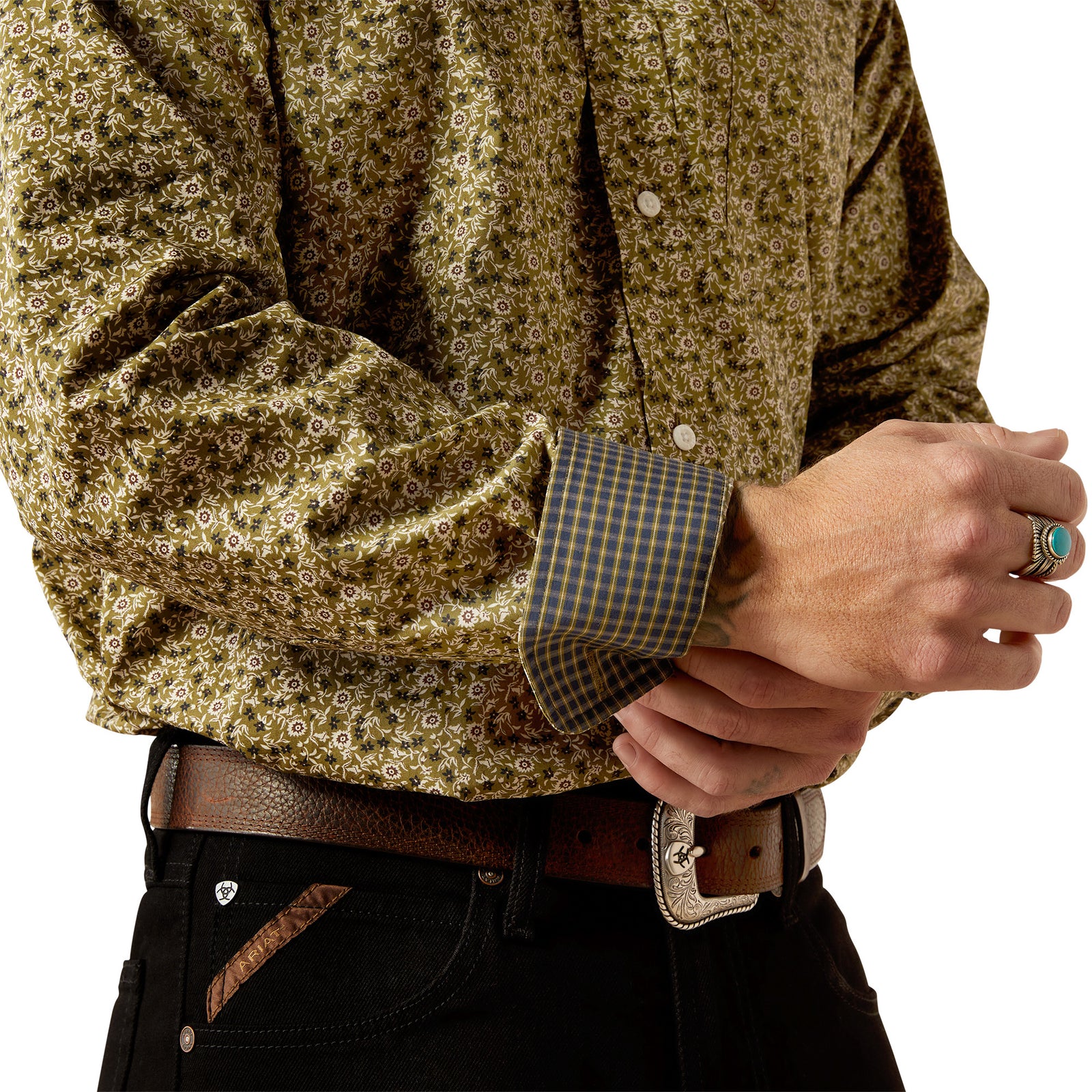 Ariat Men's Wrinkle Free Filmore L/S Western Shirt. Close-up of a person wearing a patterned shirt with rolled sleeves and a belt.