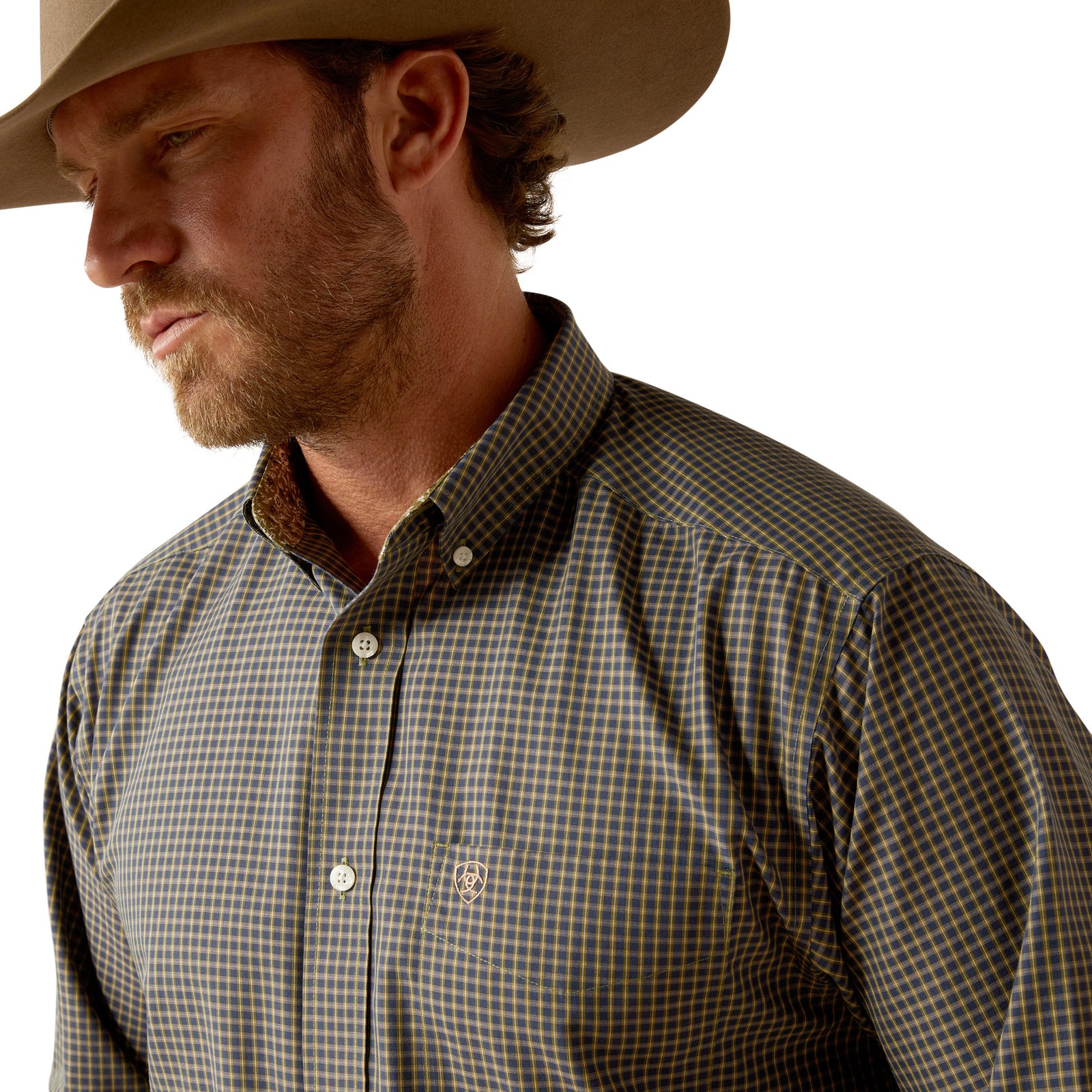Ariat Men's Wrinkle Free Ferris L/S Western Shirt. Man wearing a checkered shirt and cowboy hat against a plain background