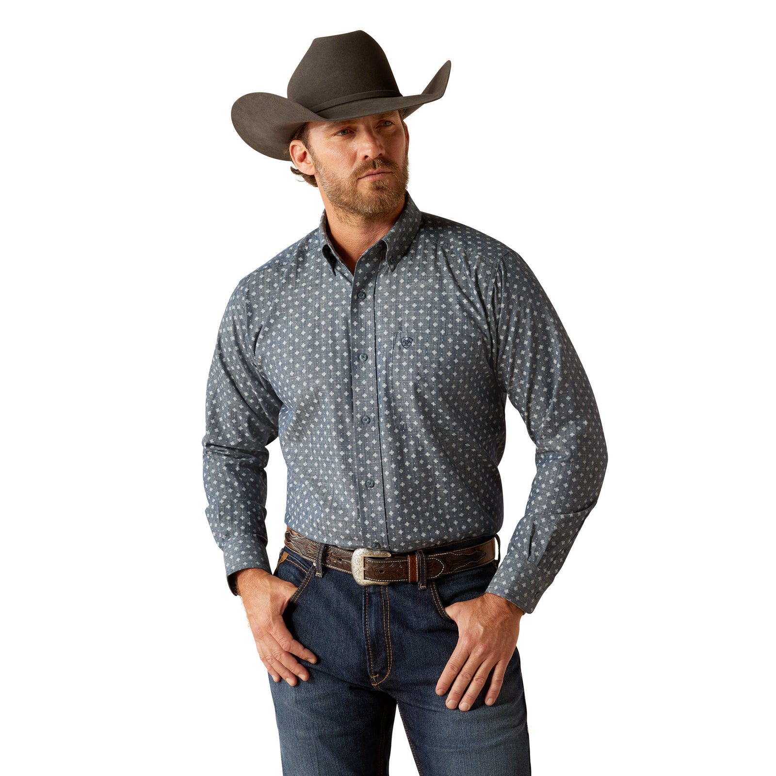Ariat Men's Chip L/S Western Shirt. A man wearing a long-sleeved geometric patterned Western shirt by Ariat, paired with blue jeans and a cowboy hat.