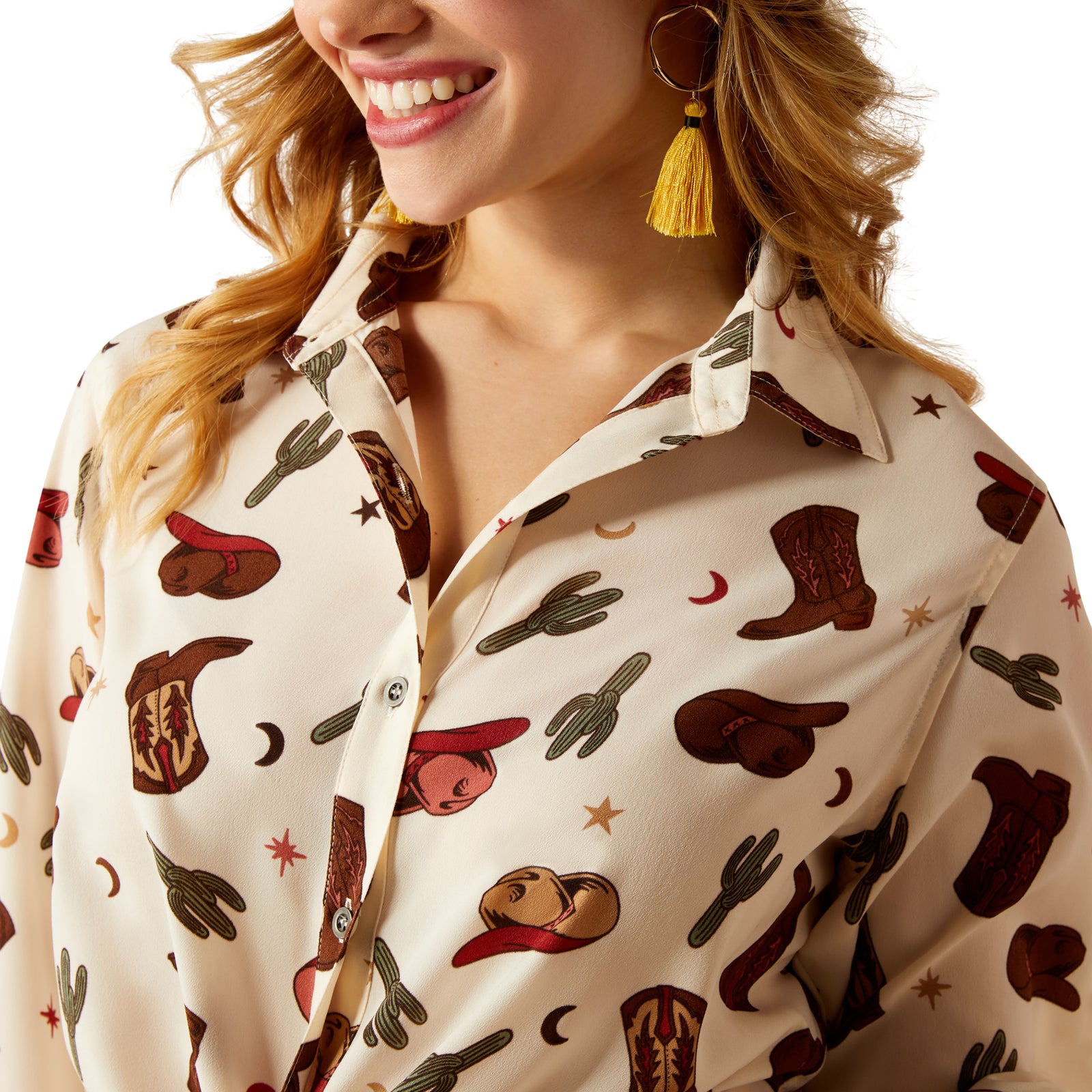Ariat Women's Homestyle L/S Western Shirt. Close-up of a person wearing a shirt with cowboy pattern on a white background.