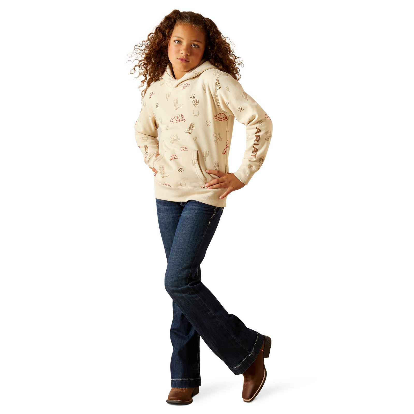 Person wearing a cream hoodie with text and blue jeans on a white background