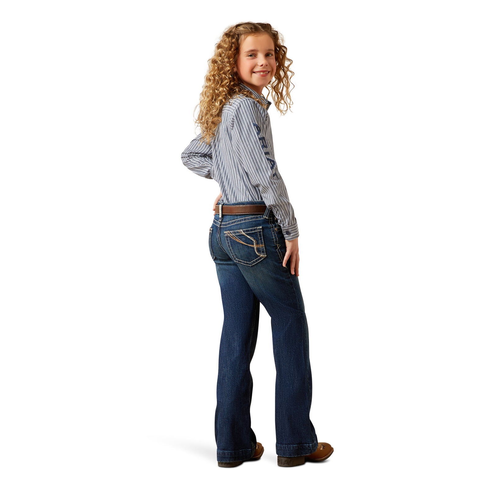Young girl wearing a striped shirt and blue jeans on a white background