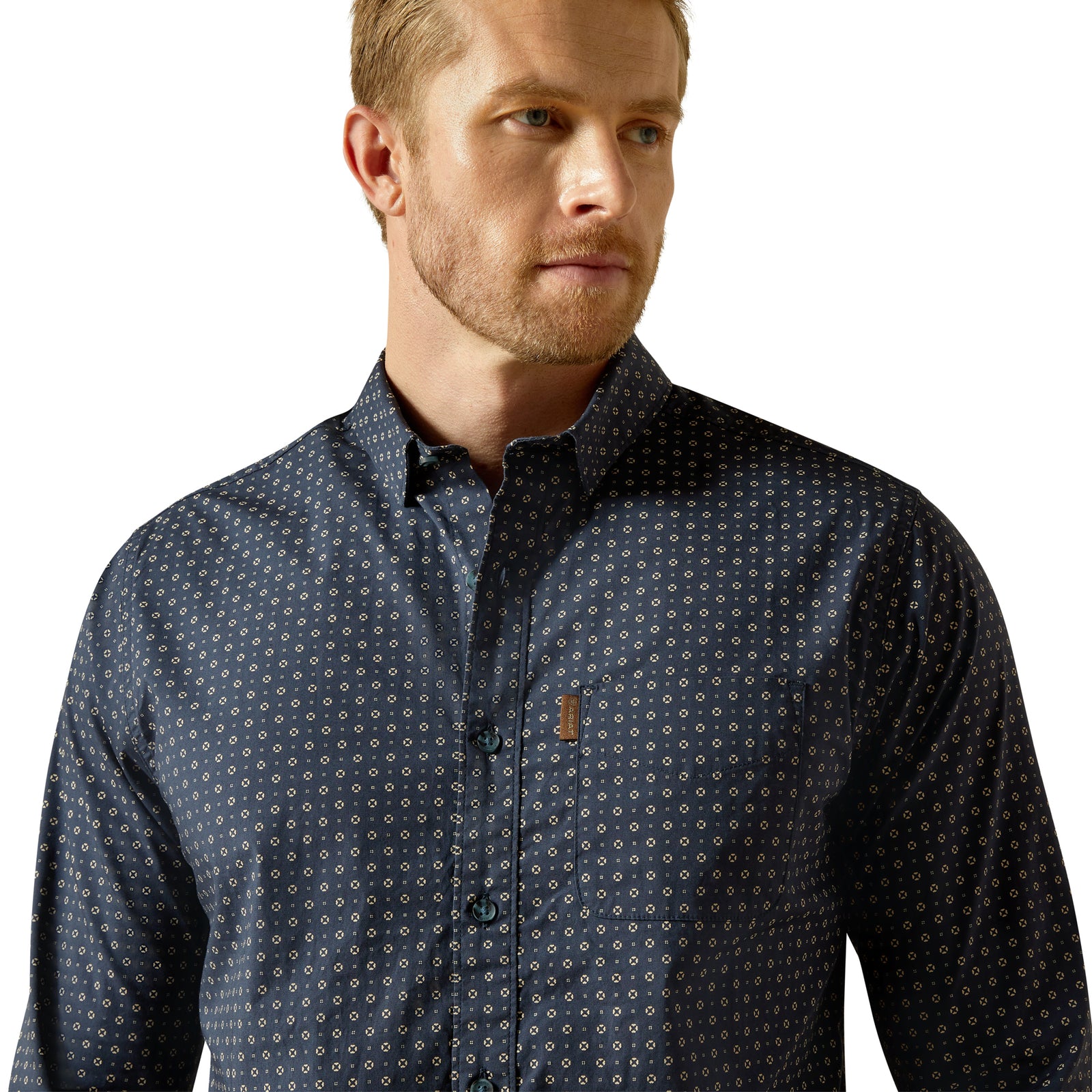 Man wearing a dark patterned shirt on a white background