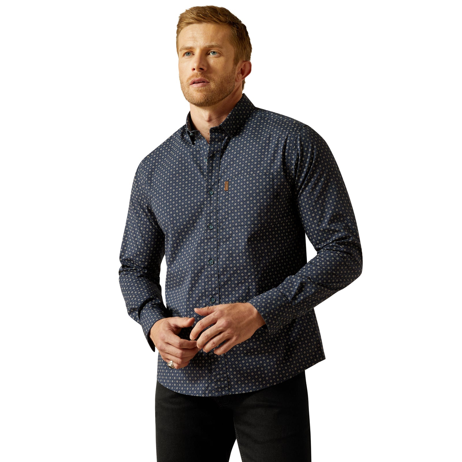 Man wearing a dark blue patterned shirt on a white background