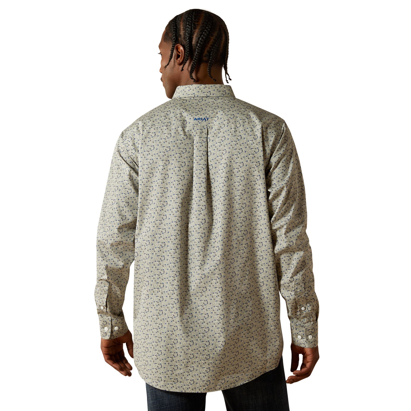Person wearing a patterned long-sleeve shirt on a white background