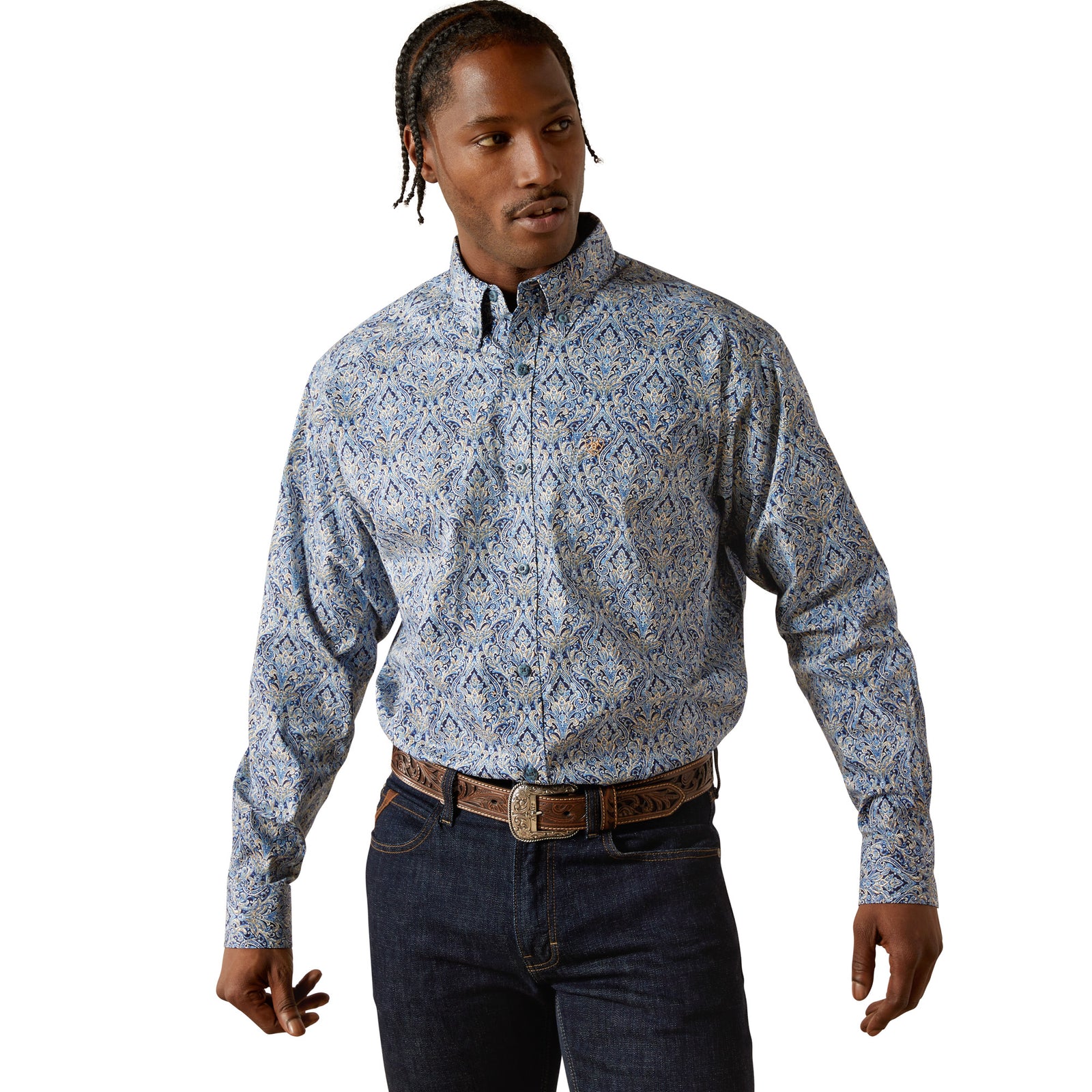 Man wearing a patterned shirt and jeans on a white background