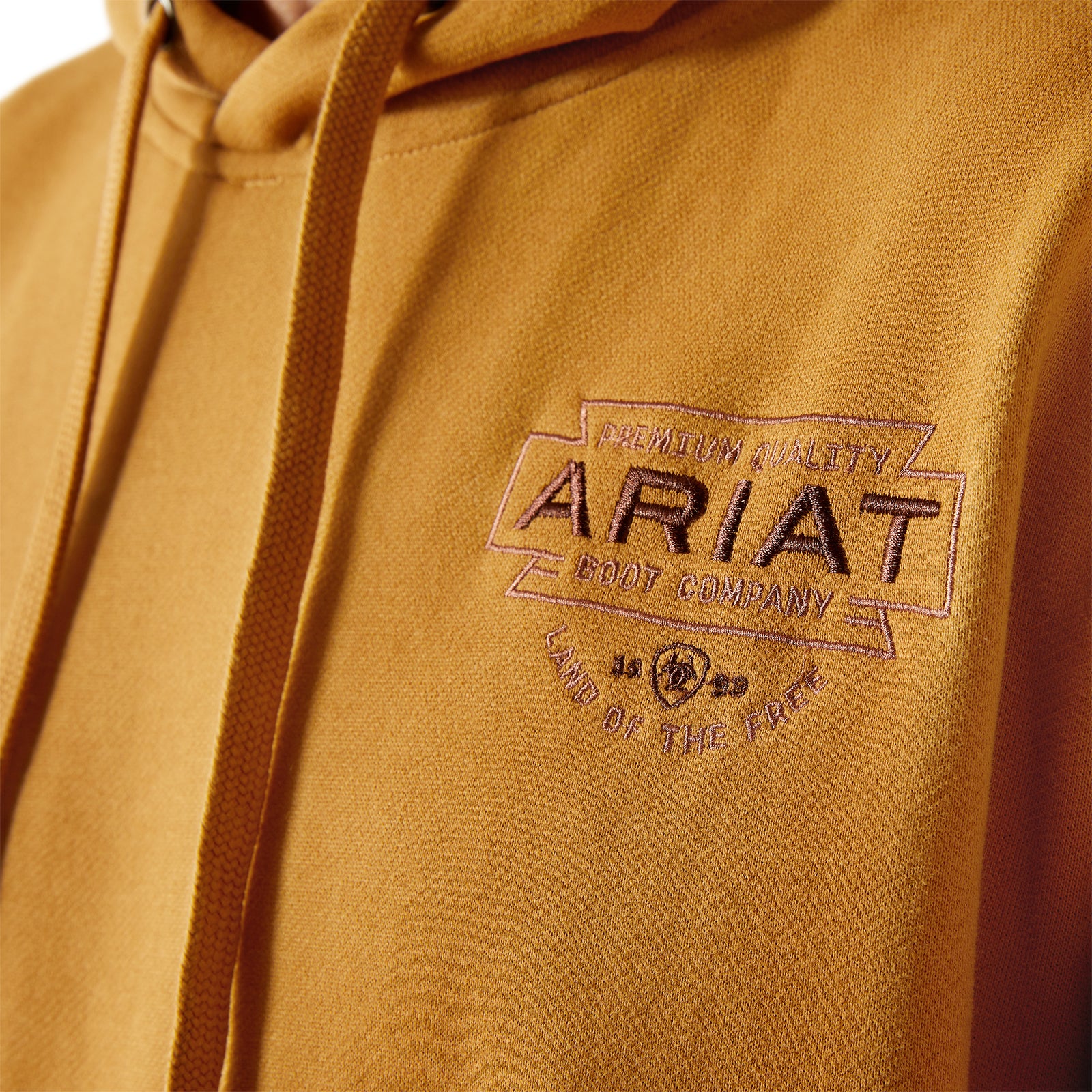 Brown hoodie with Ariat logo on a brown background