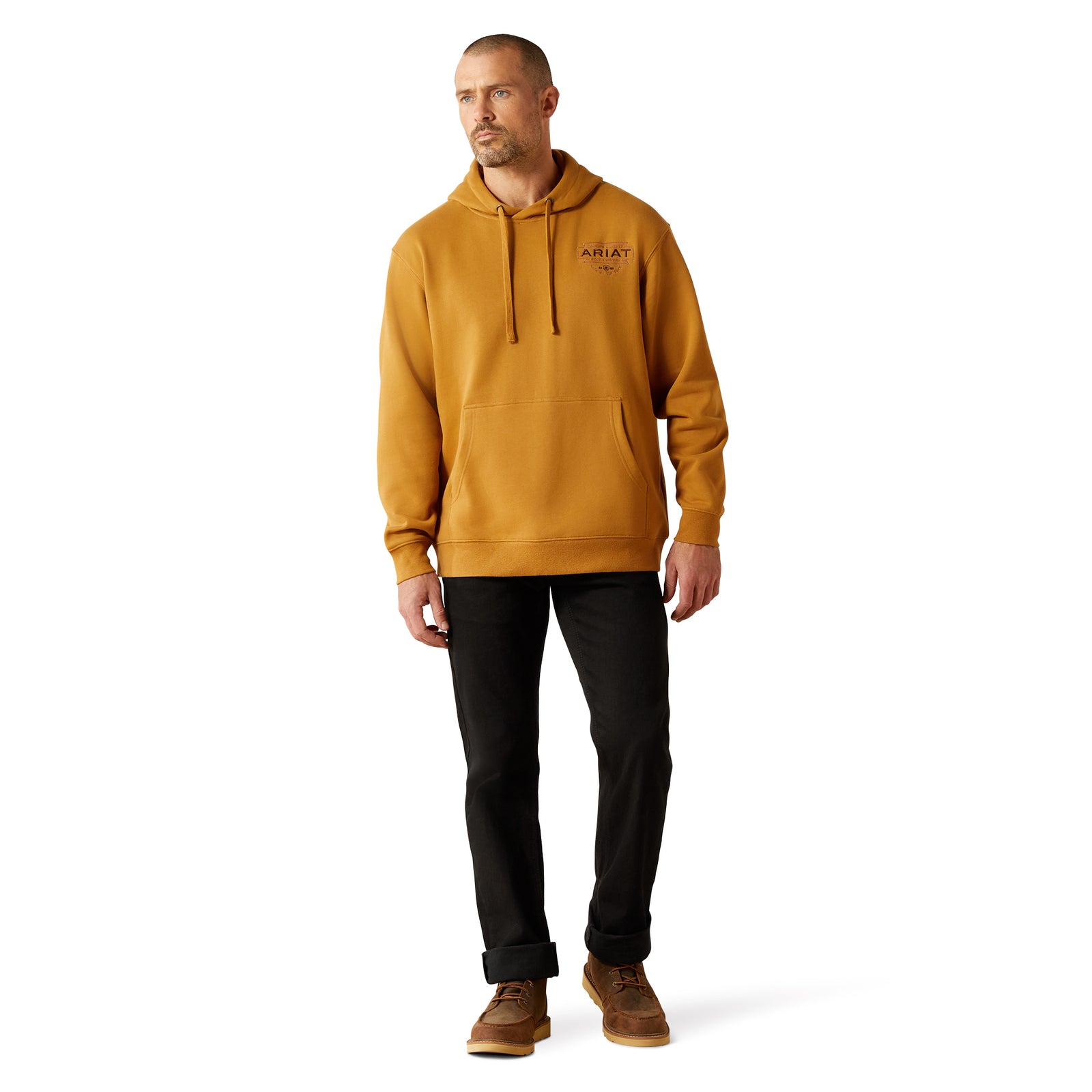 Man wearing a mustard yellow hoodie with a brand logo on a white background