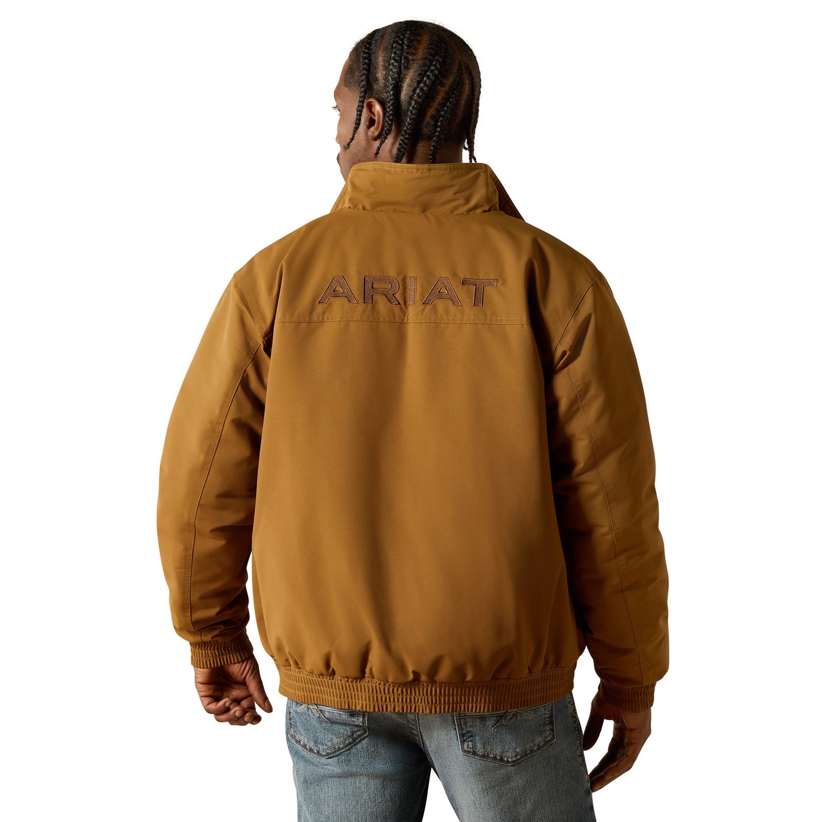 Person wearing a brown Ariat jacket on a white background