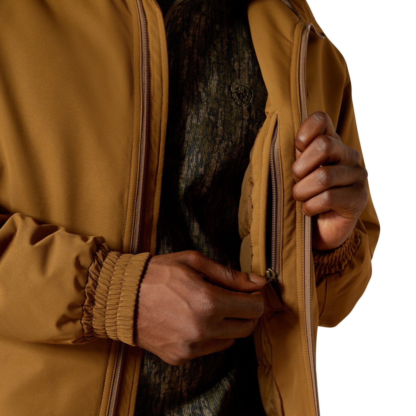 Person wearing a brown jacket holding a tree trunk