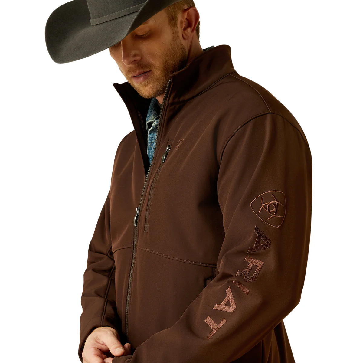 Man wearing a brown jacket with branding on a white background