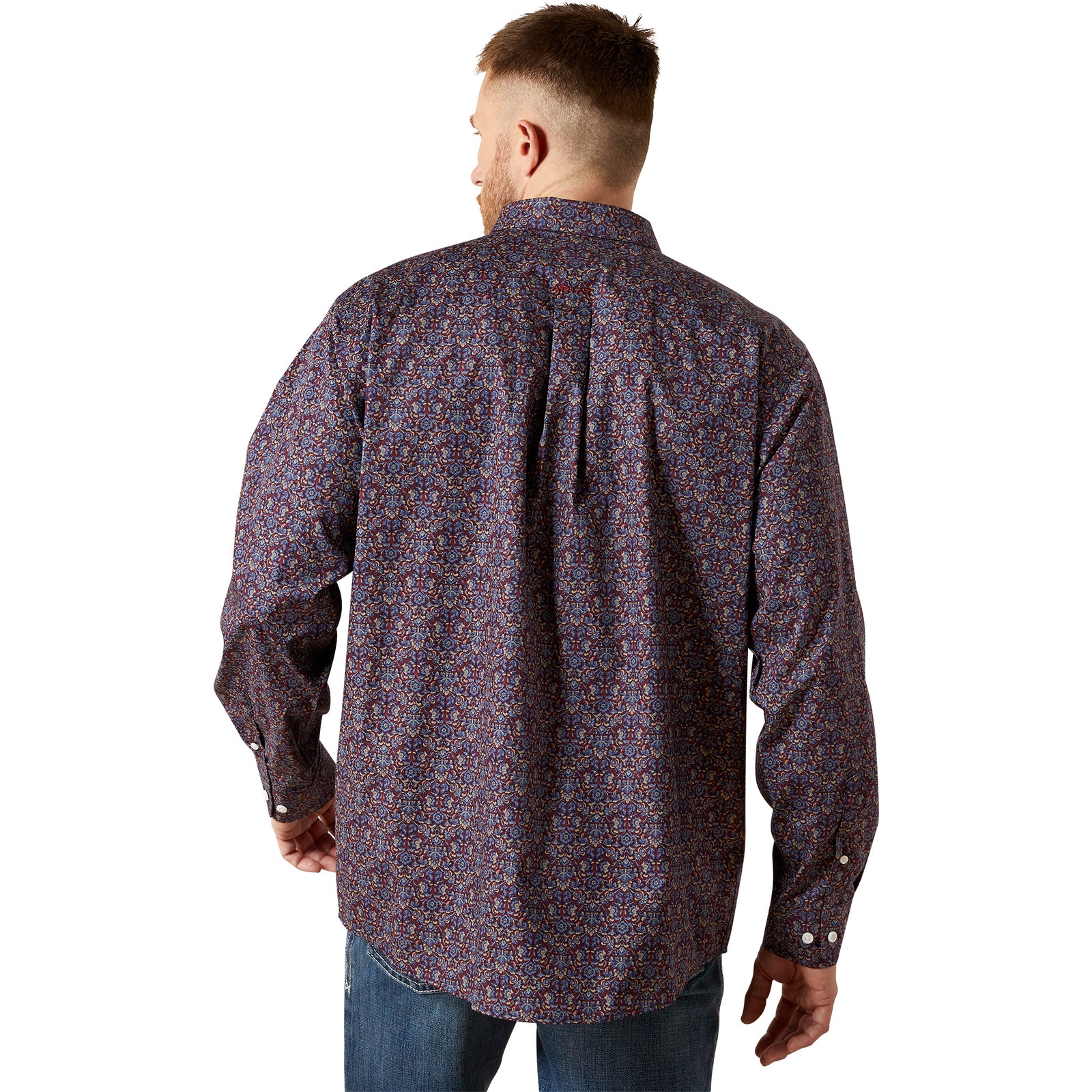 Man wearing a patterned shirt on a white background