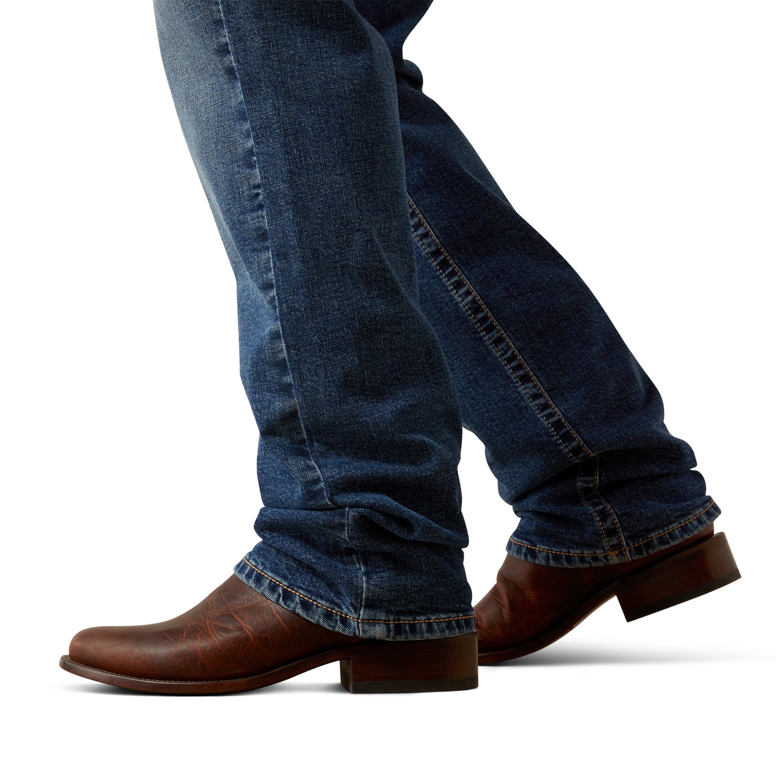 Close-up of blue jeans and brown shoes on a white background