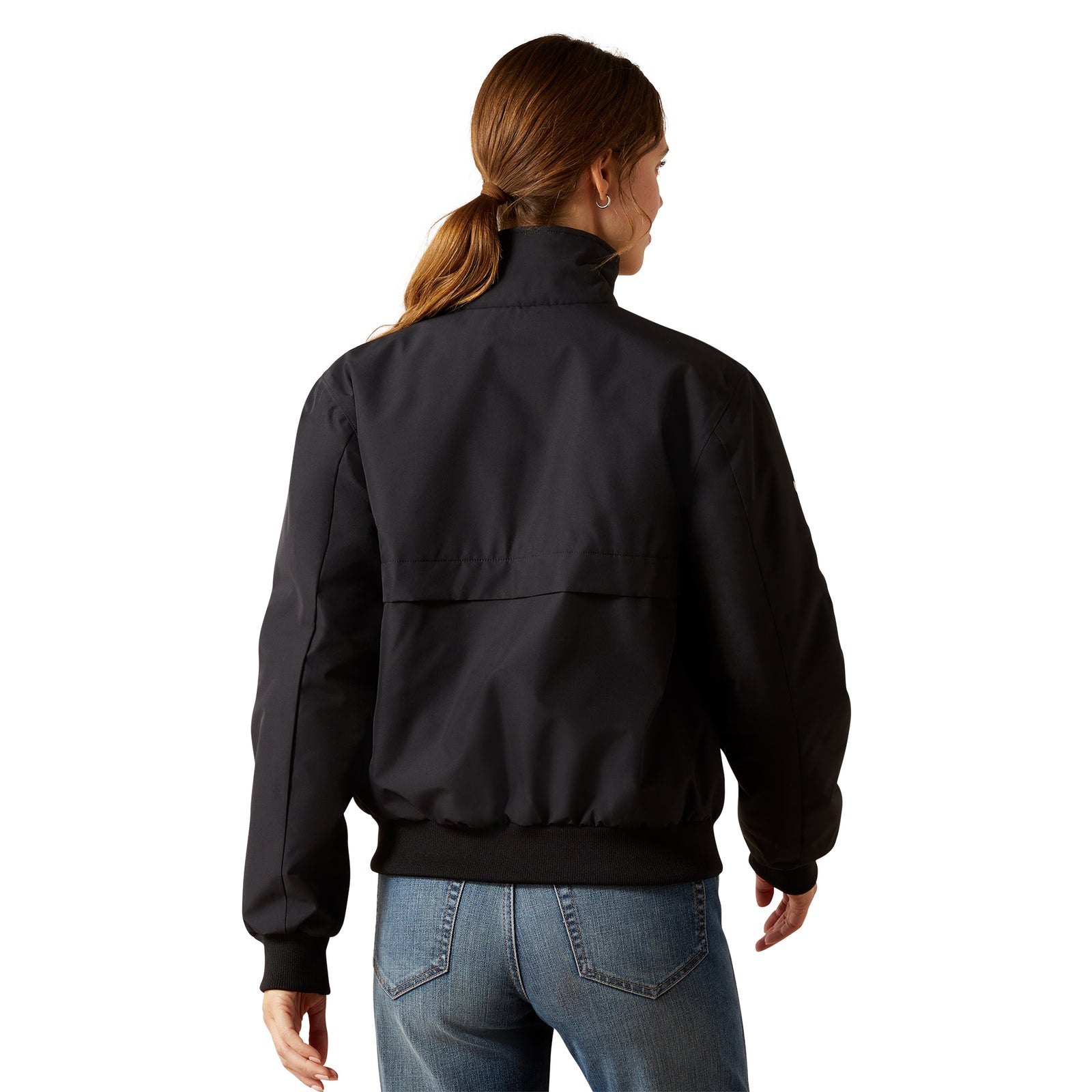 Person wearing a black jacket and blue jeans on a white background