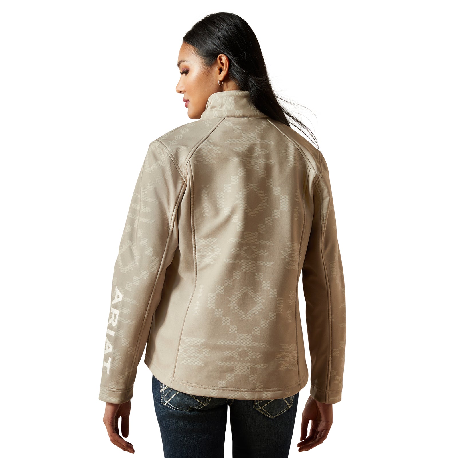 Person wearing a beige jacket with 'Ariat' branding on a white background