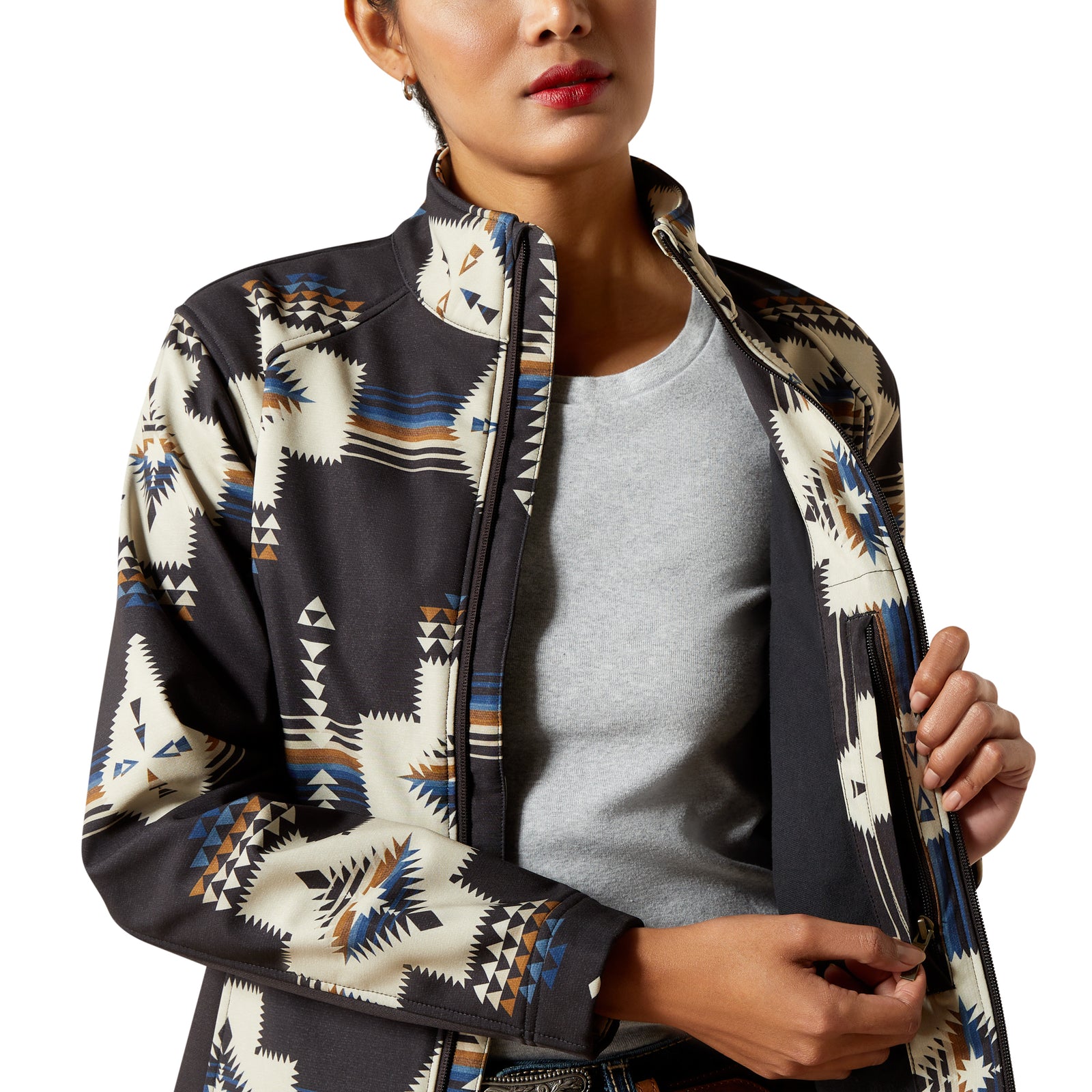 Woman wearing a patterned jacket over a gray shirt on a white background