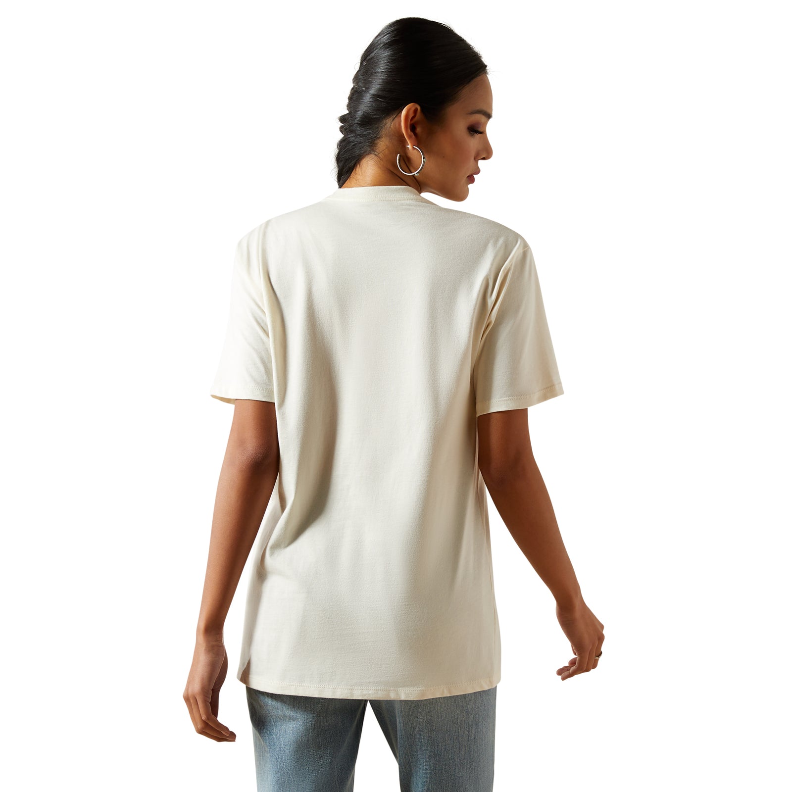 Ariat Women's Classic Rodeo T-Shirt. Woman wearing a beige t-shirt on a white background