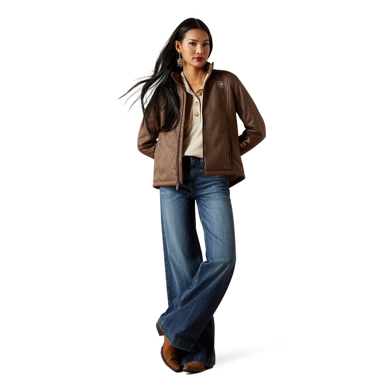 Woman wearing a brown jacket and blue jeans on a white background