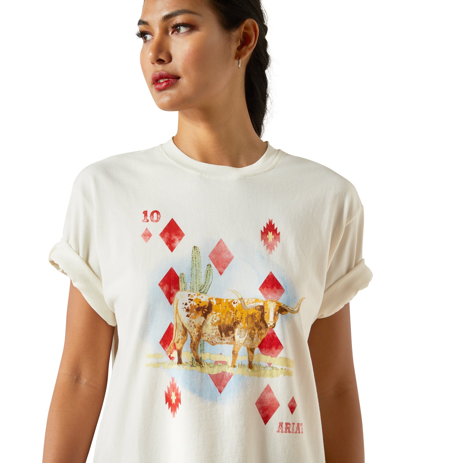 Woman wearing a white t-shirt with a graphic design of a bull and red diamonds on a white background