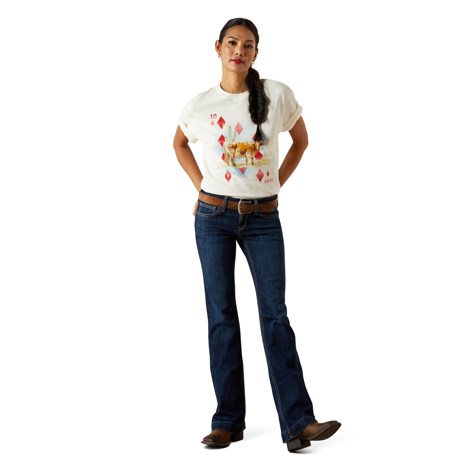 Woman wearing a white t-shirt with a graphic design and blue jeans on a white background