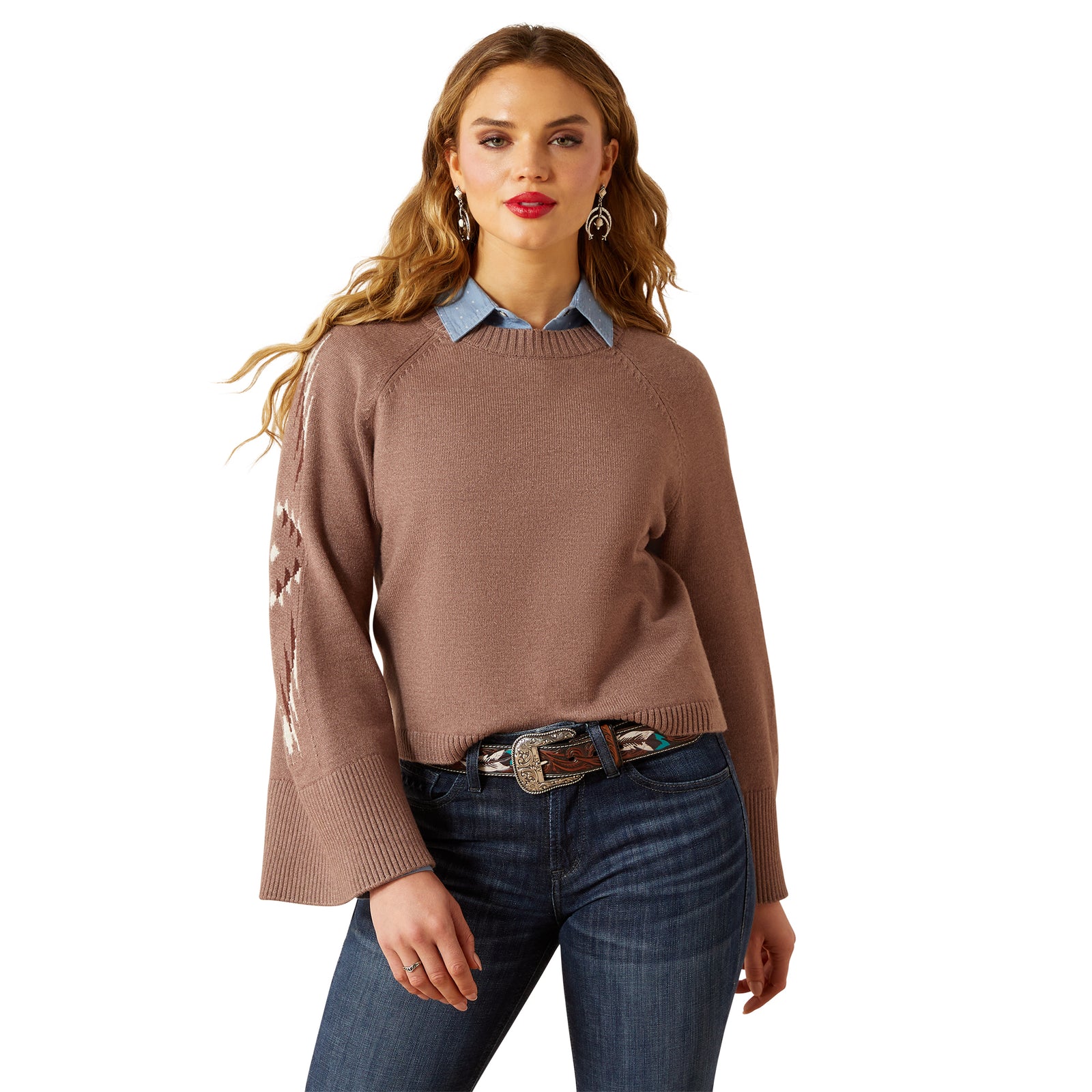 Woman wearing a brown sweater and blue jeans on a white background