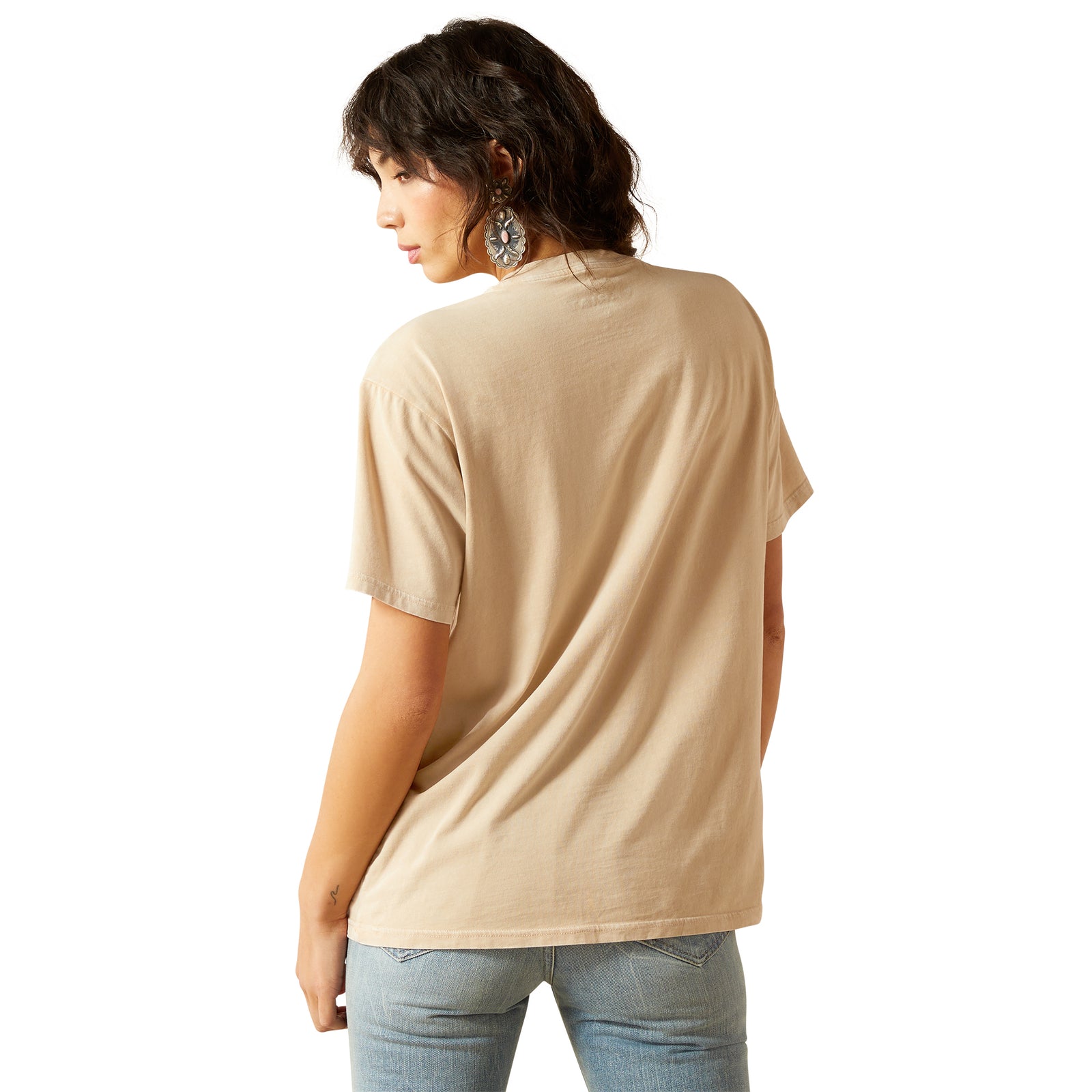 Woman wearing a beige t-shirt and blue jeans on a white background