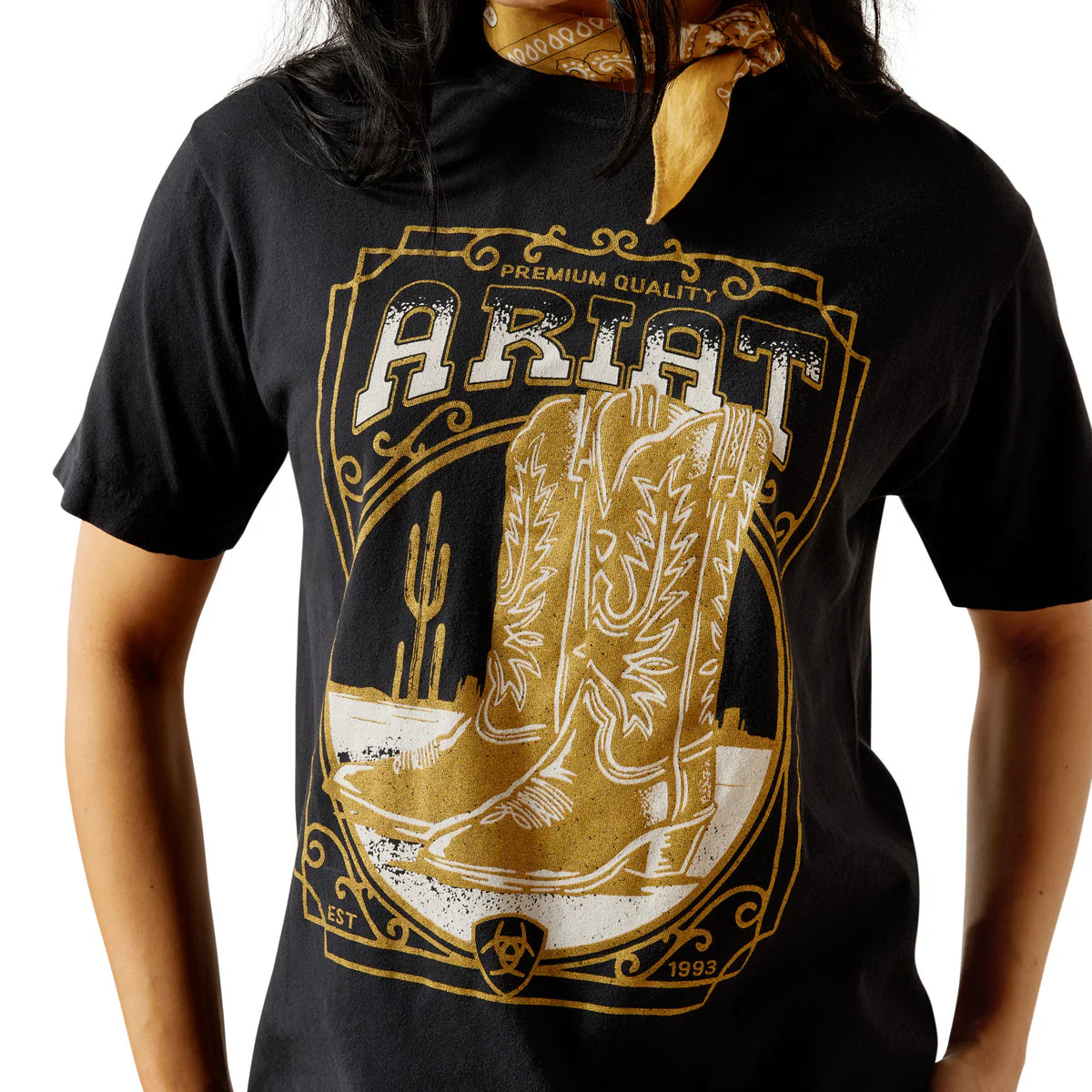 Person wearing a black t-shirt with a gold cowboy boot design and 'Ariat' branding.