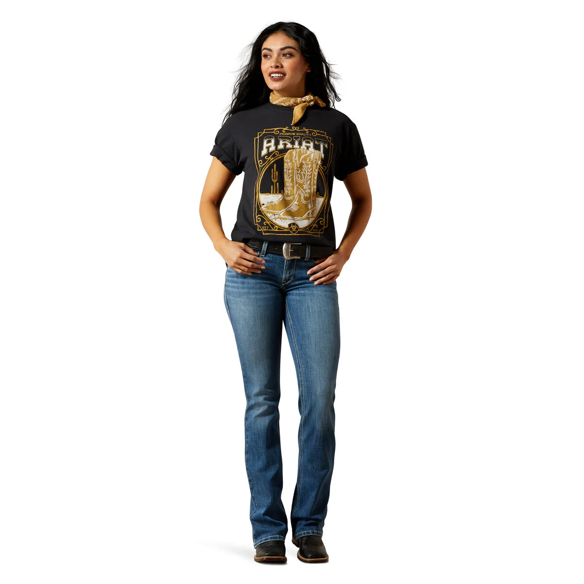 Woman wearing a black t-shirt with gold graphics and text, paired with blue jeans on a white background